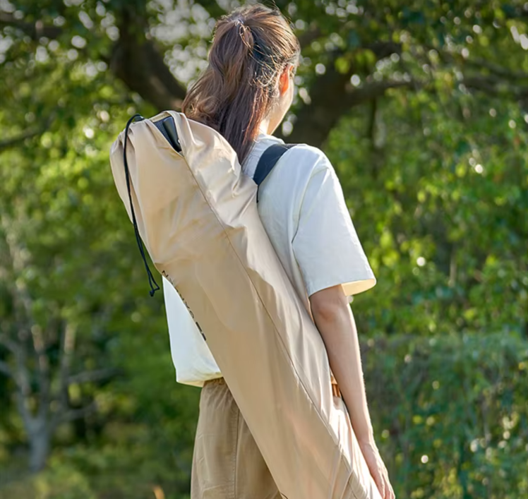 Girl carring on the back the reclining chair with a storage bag