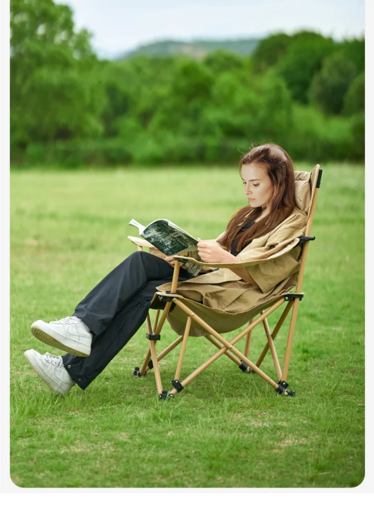 Girl sitting on reclining camping chair