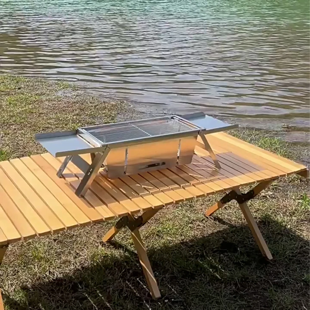 Barbecue grill on a table next to a lake