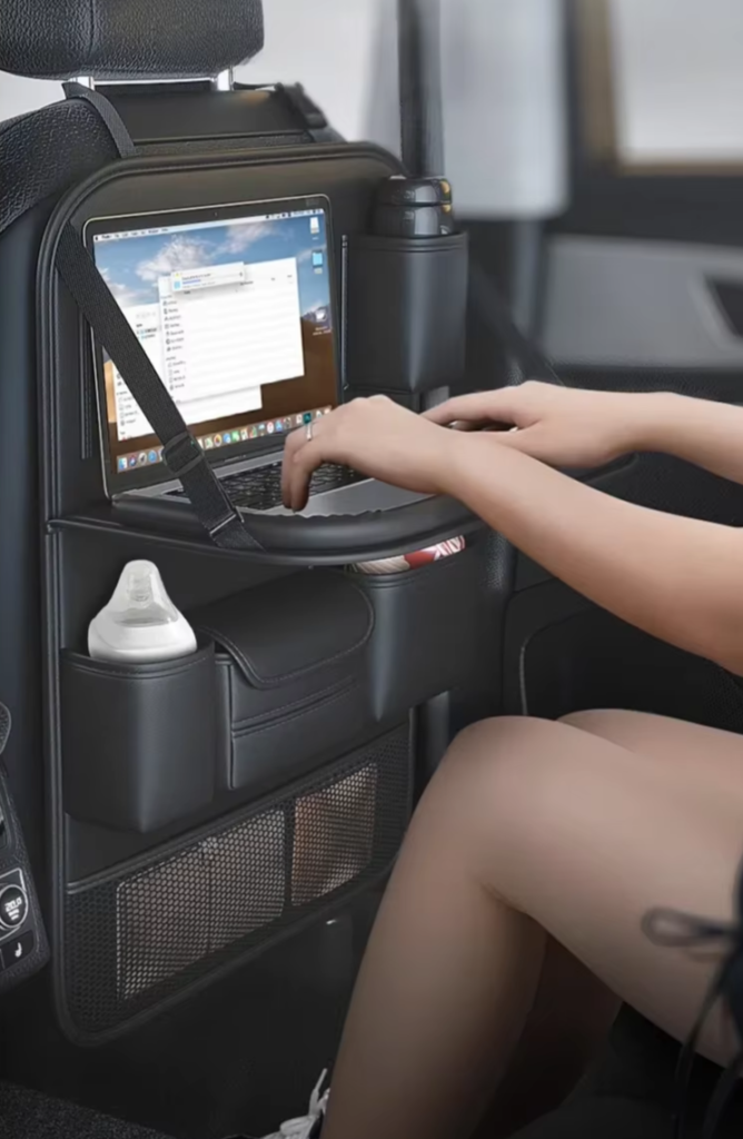 typing in a notebook on the Seat Back Storage Bag